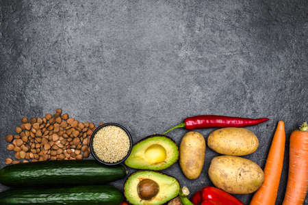 Healthy food background. Healthy vegetarian food. Vegetables and fruits on black stone. Clean vegetarian eating concept.の写真素材