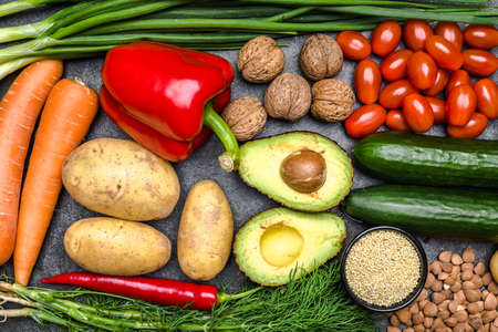 Healthy food background. Healthy vegetarian food. Vegetables and fruits on black stone. Clean vegetarian eating concept.の写真素材