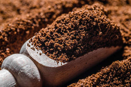 Aromatic ground coffee in spoonの写真素材