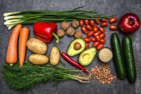 Healthy food background. Healthy vegetarian food. Vegetables and fruits on black stone. Clean vegetarian eating concept.の写真素材