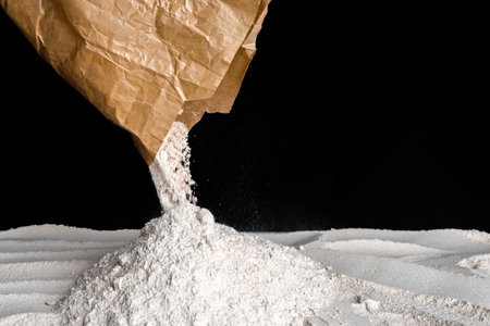 Chef pouring flour on the table. Preparing dough with whole grain flour. Baking concept.の写真素材
