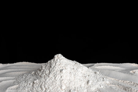 Background with flour. Pile of sifted spelled flour on black background.の写真素材