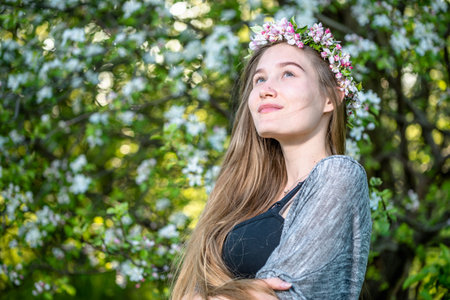 Beautiful portrait of woman with flower wreath on head. Beauty girl with flowers hairstyle. Fashion photo.の写真素材