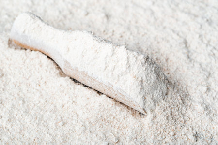 Baking background with flour in wooden scoopの写真素材