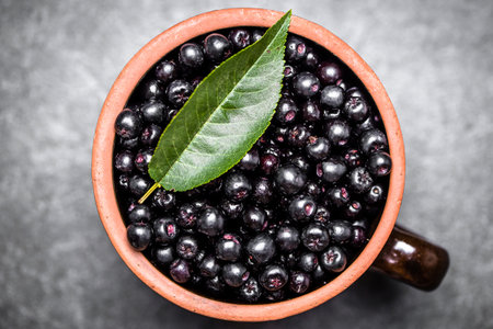 Chokeberry. Bowl of fresh chokeberry berries, top view.