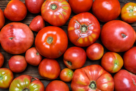 Organic tomatoes on farmer market. Farm fresh tomatoes on wooden table. Organic vegetables background.の写真素材