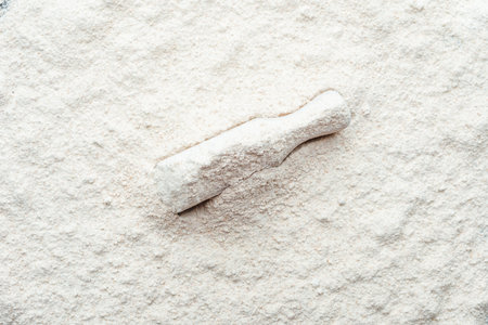 Baking background with flour in wooden scoopの写真素材