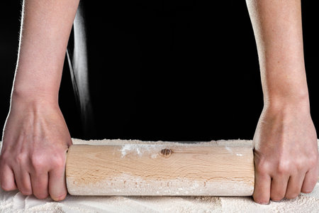 Chef hands with rolling pin on flour. Baking bread concept.の写真素材