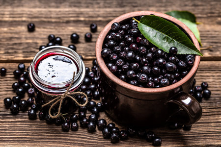 Aronia jam and fresh berry on wooden table.の写真素材