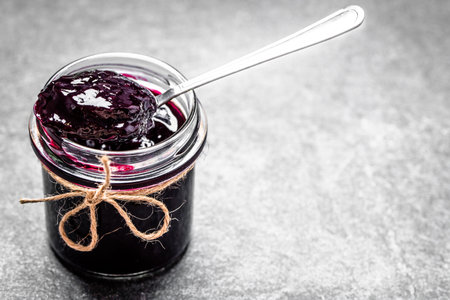 Aronia jam and fresh berry on stone table.の写真素材