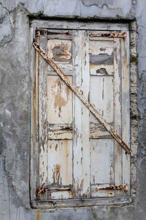 old window painted white oil, paints spilled, iron locked