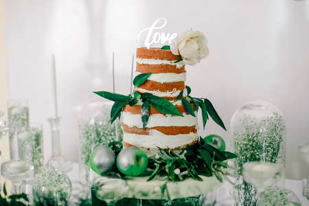 engagement cake adorned with green leaves and applesの写真素材