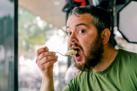 the hungry man who eats a sweetの写真素材