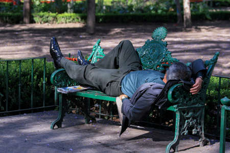 The man who sleeps at noon on a bench in the parkの写真素材