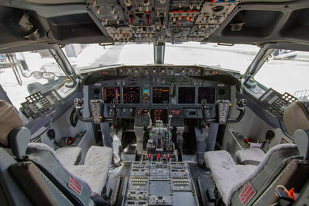 A view of the cockpit of a large commercial airplane a cockpit . Cockpit view of a commercial aircraft cruising Control panel in a plane cockpit.の写真素材