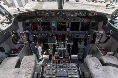 A view of the cockpit of a large commercial airplane a cockpit . Cockpit view of a commercial...