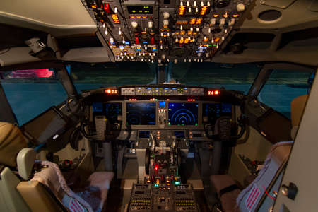 A view of the cockpit of a large commercial airplane a cockpit . Cockpit view of a commercial aircraft cruising Control panel in a plane cockpit.の写真素材