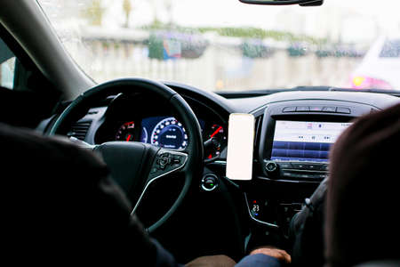 Inside view of the car and mobile phone by the steering wheel, copy spaceの写真素材