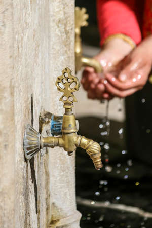 Washing your hands in a historic fountainの写真素材