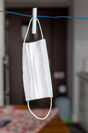 To dry the face mask by hanging it on a rope