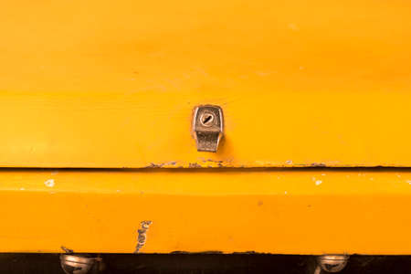 Trunk lock details of an antique yellow car in Turkey