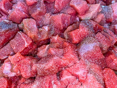 Meat cut into morsel sized pieces in the potの写真素材