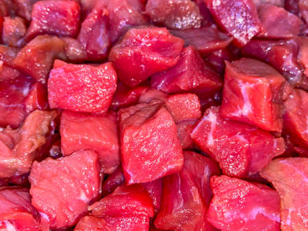 Meat cut into morsel sized pieces in the potの写真素材