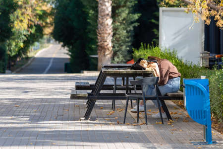 A student falling asleep in the schoolyard after classの写真素材