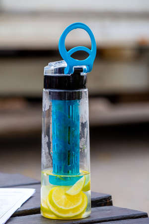 Water with lemon and rosemary herb in a flaskの写真素材