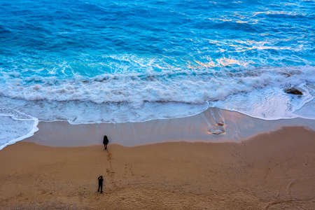 A couple taking photos by the sea. turquoise sea