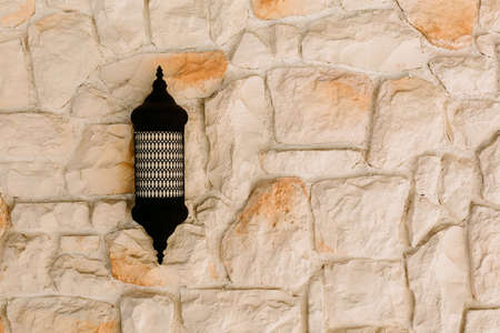 The texture of a stone wall. Sconce and Stone wall as background or textureの写真素材