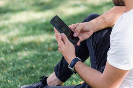 Male hand holding mobile phone. blank background.の写真素材