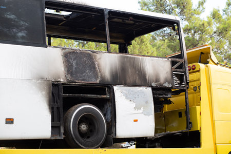 A bus with a burnt backside.