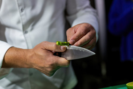 The cook chopping asparagus. Chopping vegetables with a knifeの写真素材