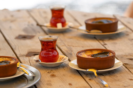 Turkish tea and rice pudding on the wood tableの写真素材