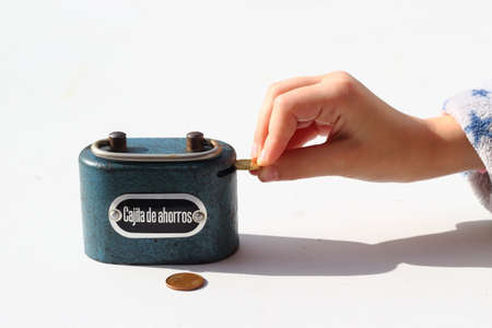 Saving the savings in the piggy bankの写真素材