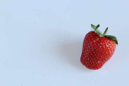 Strawberry fruit on gray background. Red Greenの写真素材