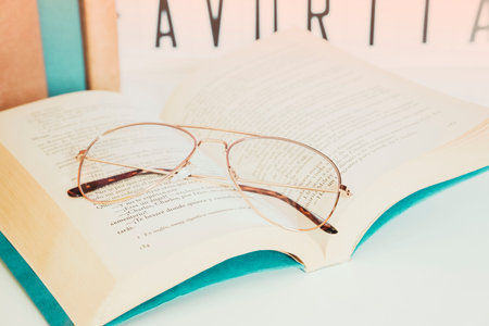 Close-up close-up. International Book Day, open book with a pair of glasses on the bedside table in the bedroom.の写真素材