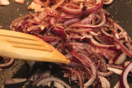 Cooking and stirring grilled red onion.の写真素材