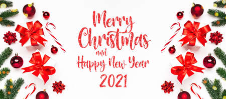 Merry Christmas and Happy New Year 2021 greeting card background with lettering. Christmas gifts and decor on white background top view. Winter xmas holiday theme in flat lay styleの写真素材