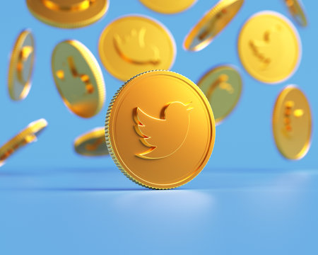 Valencia, Spain - February, 2023: golden Twitter coins falling on a blue background in 3D. Twitter is working on a feature called Coins which will allow users to support creators on the platformのeditorial素材