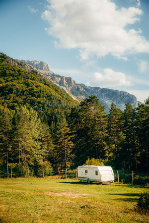 Caravan with amazing landscape views of forest and mountains. Camping holiday and outdoor summer vacation. Nomad lifestyle conceptの写真素材