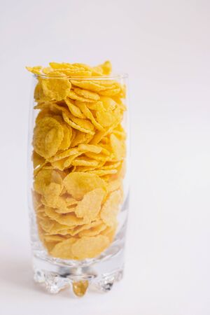 Glass Cup filled with corn flakes.A light, delicious snack. Corn products. Muesli for Breakfast.