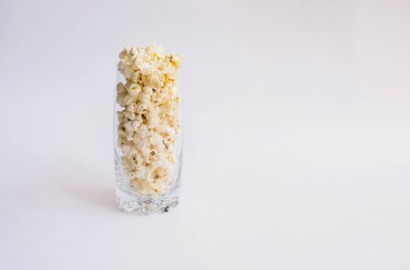 Glass Cup filled with popcorn. A light, delicious snack. Corn products.Food for watching movies.の写真素材