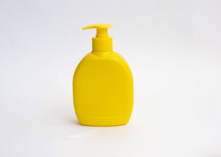 Shower gel, liquid soap plastic bottle of yellow color with a place for the text. Hand hygiene.の写真素材
