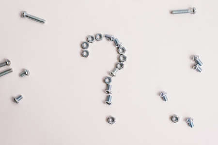 Question mark lined with bolts and nuts on whiteの写真素材