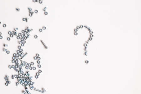 Question mark lined with bolts and nuts on whiteの写真素材