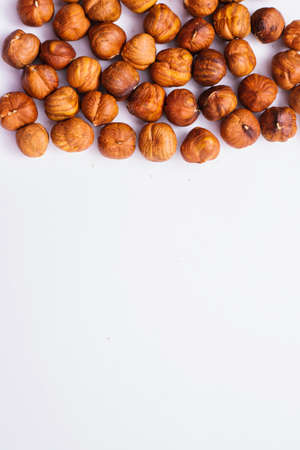 Whole hazelnut kernels lie on a white background. The autumn harvest. Hazelnut.