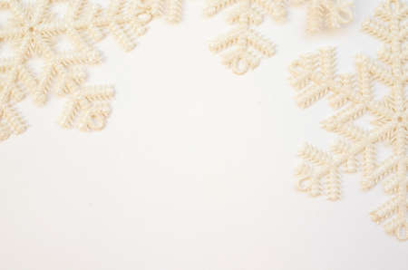 Christmas or winter composition. Pattern of white snowflakes on a white background. The concept of...