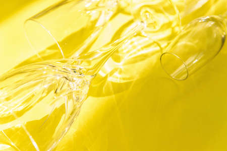 Empty glasses stand on a yellow background, top view.の写真素材